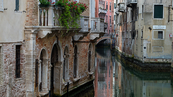 peaceful canal in Venice with footbridge